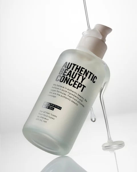 Bottle of 'Authentic Beauty Concept' product on a white background