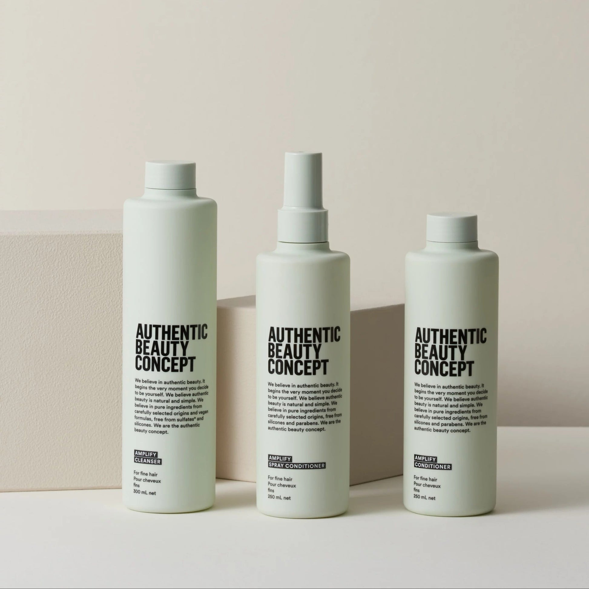 Three bottles of 'Authentic Beauty Concept' on a light background